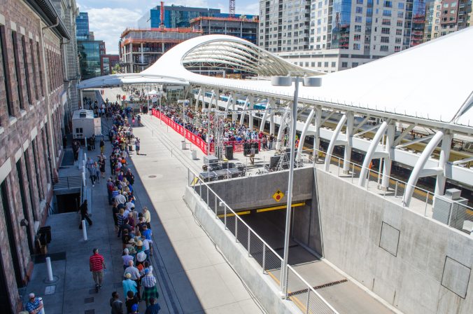 The queue to board the A line to DIA wrapped around the side of Union Station by the time we arrived on the first train. A public train had left Union Station towards DIA at the same time as ours. The tunnel in the foreground is the entrance to the underground bus depot.